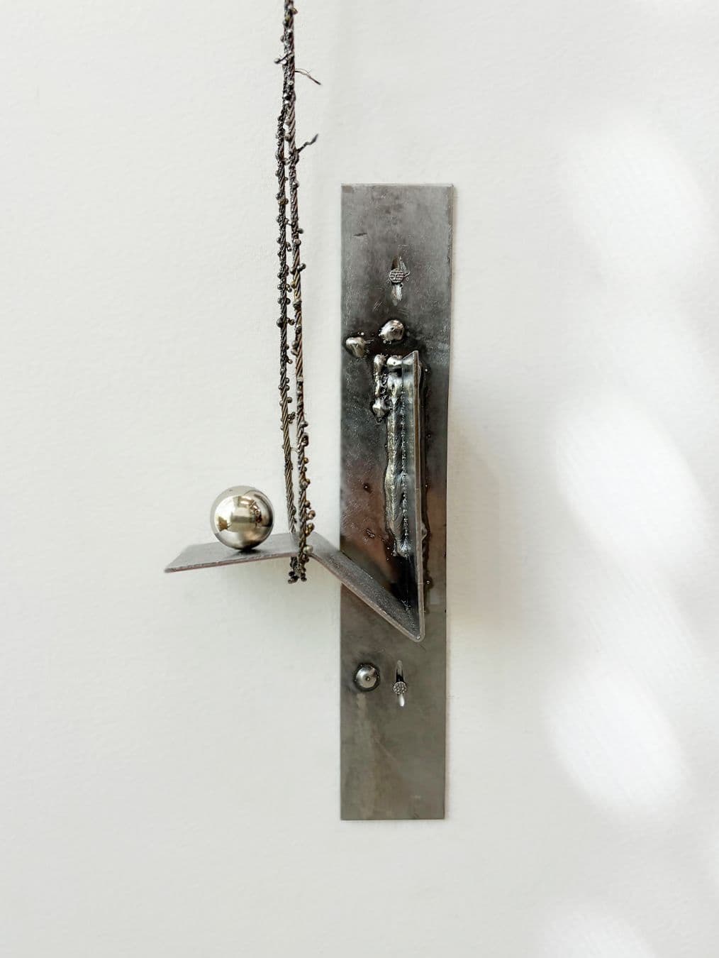 A fragment of a steel cable sculpture from the series Seam.