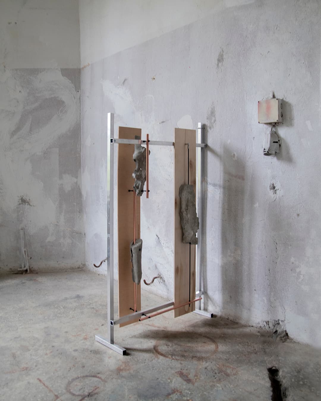 One of the sculptures from the series Displaced, with concrete castings of apple tree roots and copper elements.
