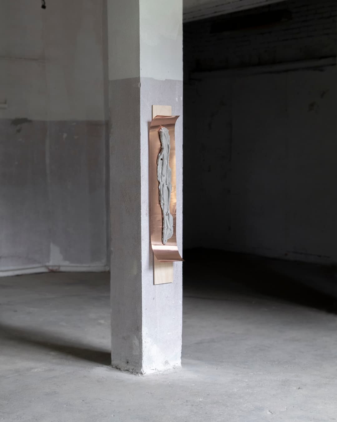 One of the sculptures from the series Displaced, with concrete castings of apple tree roots and copper elements