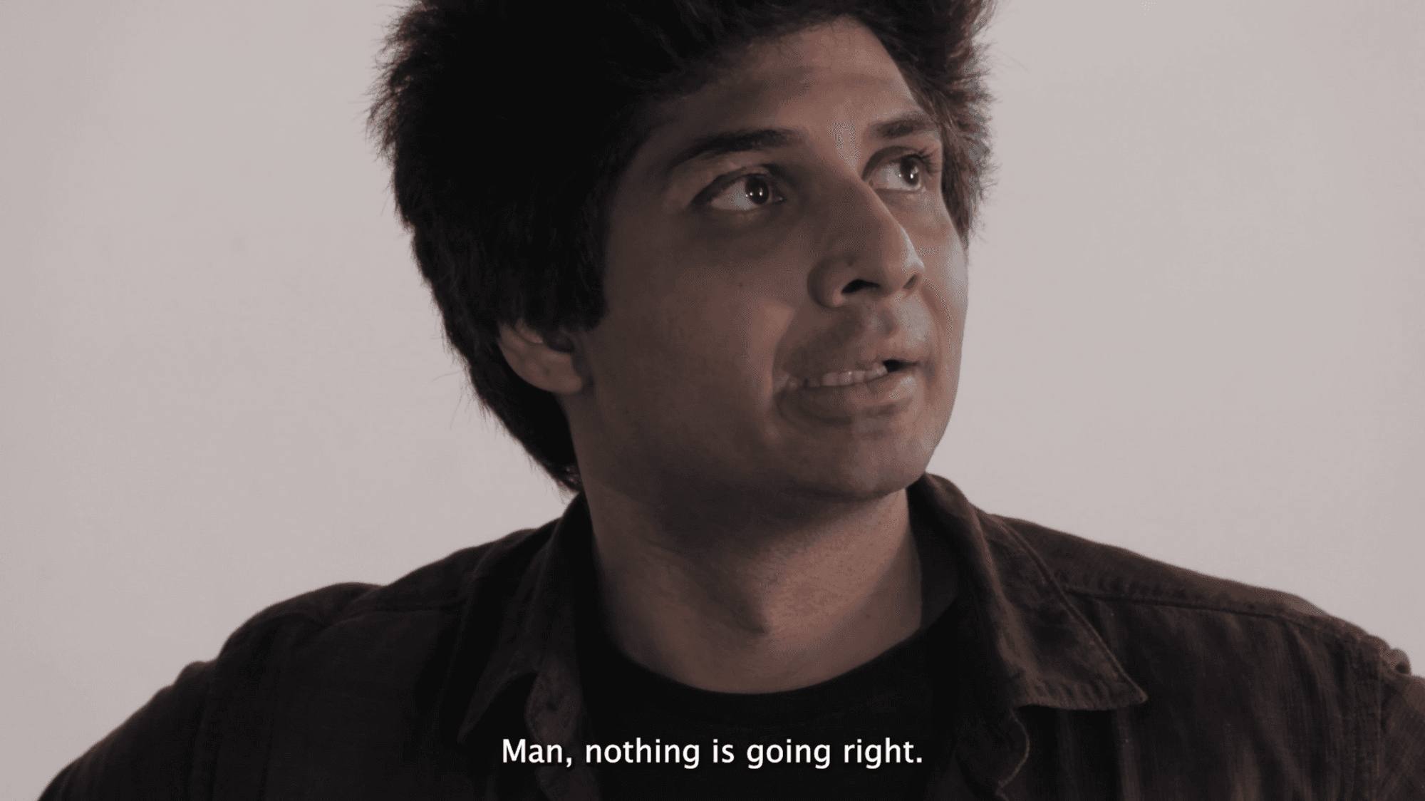 Headshot of a man, contemplative facial expression