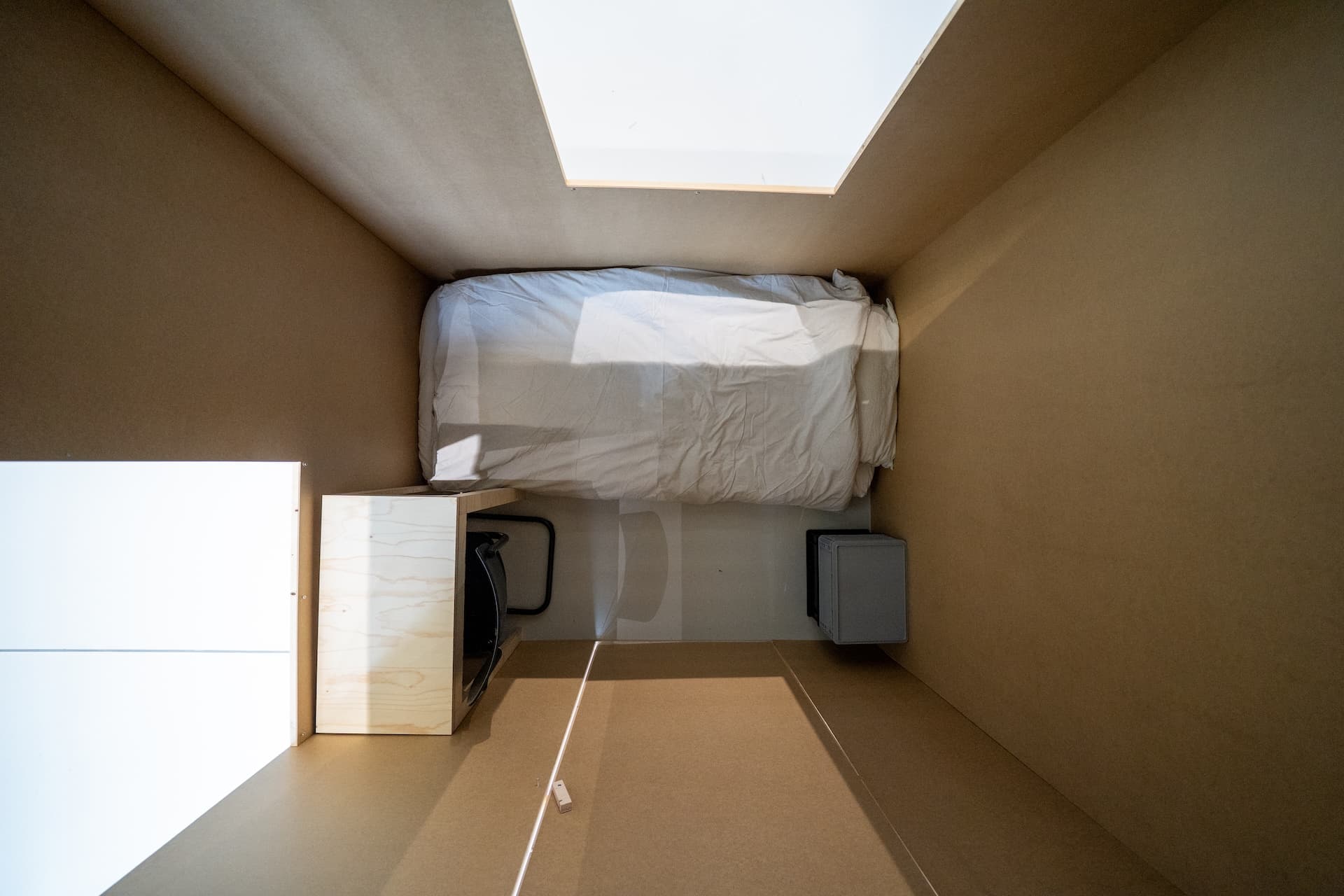 inside of a room that is 2 x 1,62 meters. objects in the room: a mattress, desk, chair, box. room is empty. 