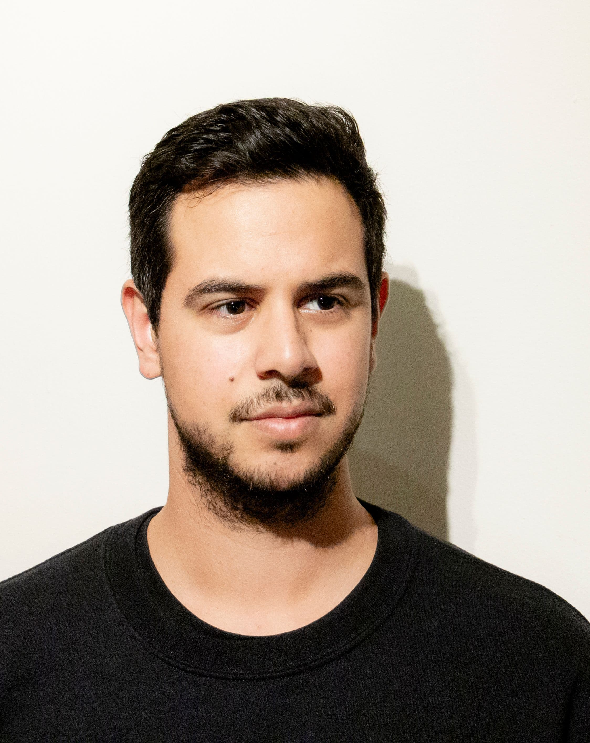 Latin-American person wearing a black sweatshirt.