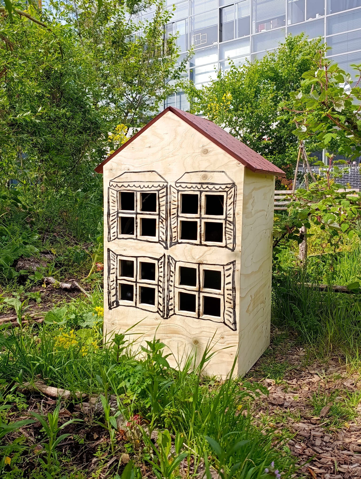 a huge bird mansion in the middle of a green space